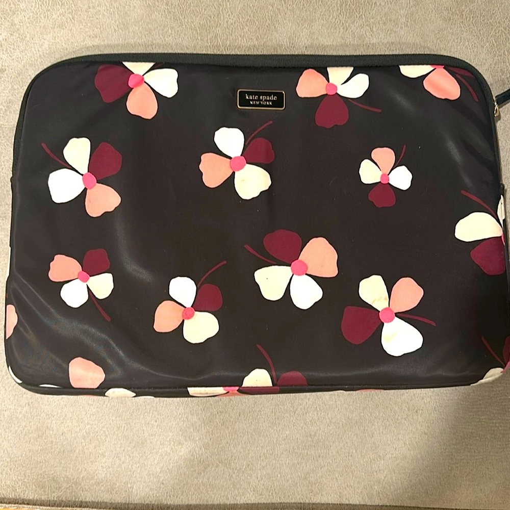 Laptop sleeve black with flower prints, small stain on bottom right